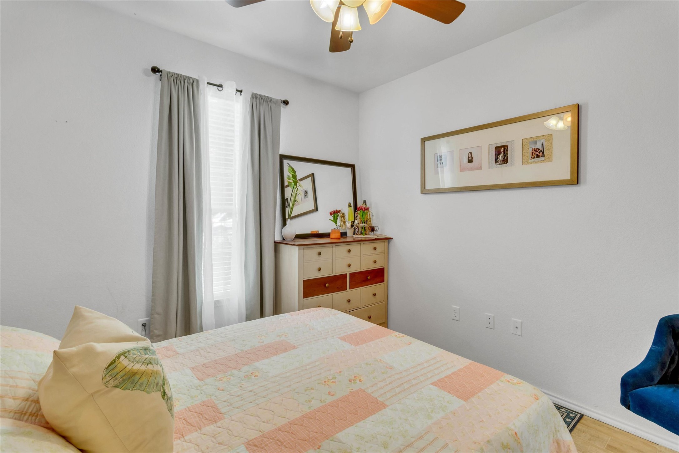 460 Waterleaf Boulevard Kyle, TX 78640 - Photo 18 of 30 A well-lit bedroom with a ceiling fan offers comfortable and serene living.