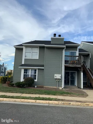 a front view of a house with a garden and plants