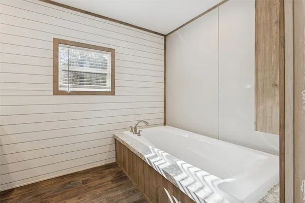 a bathroom with a tub and a window