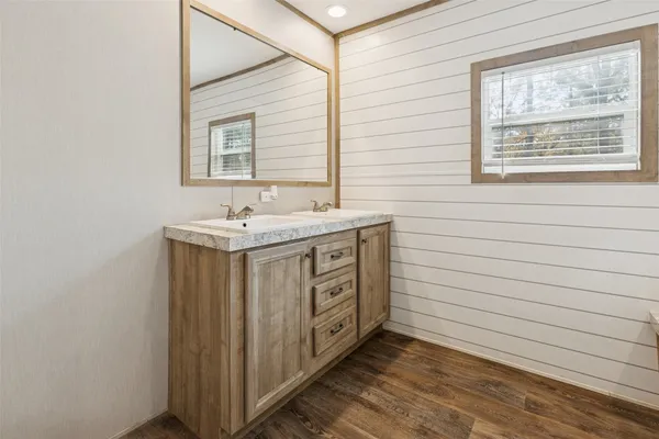 a bathroom with a sink a vanity and a mirror