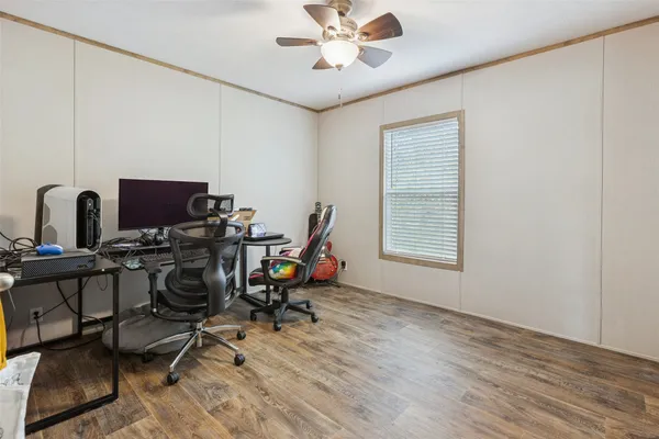 a view of a workspace with furniture and a window