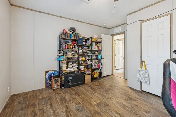 a view of a storage & utility room with clothes shoes and a chandelier