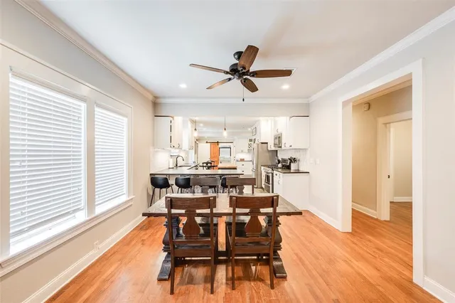 a view of a dining room with furniture window and wooden floor