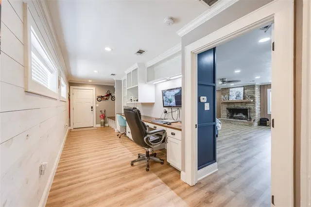 a view of a hallway with wooden floor and furniture