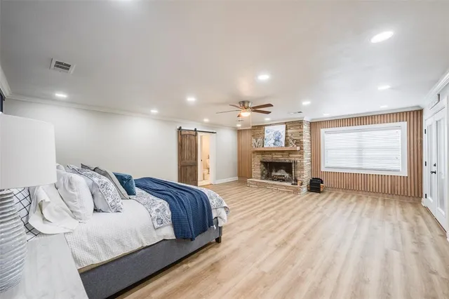 a spacious bedroom with a bed and a fireplace
