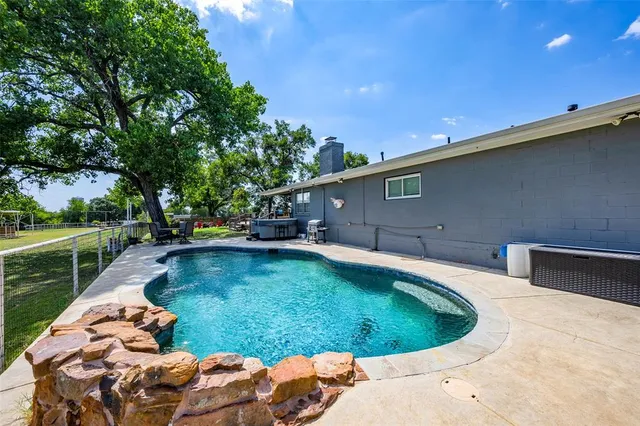 a view of a swimming pool with a patio