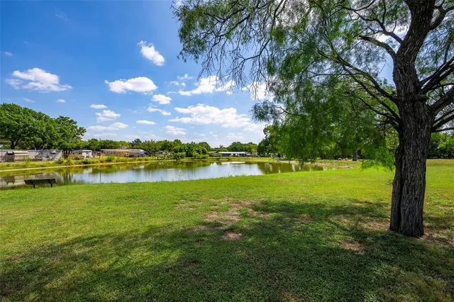 a view of a lake with houses in the background