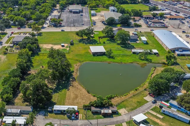 an aerial view of a residential houses with outdoor space and swimming pool