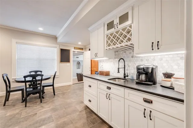 a kitchen with cabinets a sink and appliances