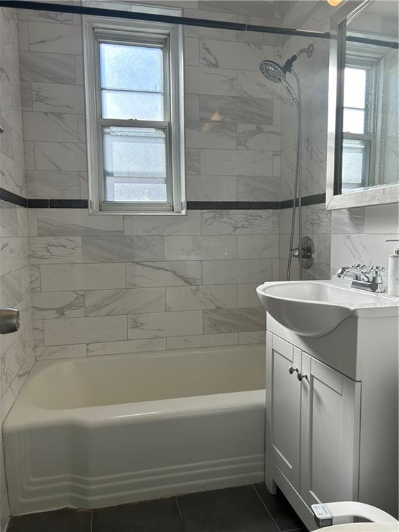 2232 Brigham Street, Unit 2K Brooklyn, NY 11229 - Photo 11 of 14 a bathroom with a bathtub a shower a sink and a toilet