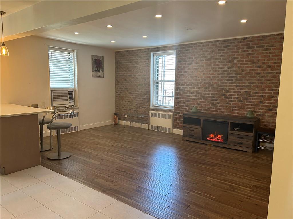 2232 Brigham Street, Unit 2K Brooklyn, NY 11229 - Photo 4 of 14 a living room with furniture and a fireplace