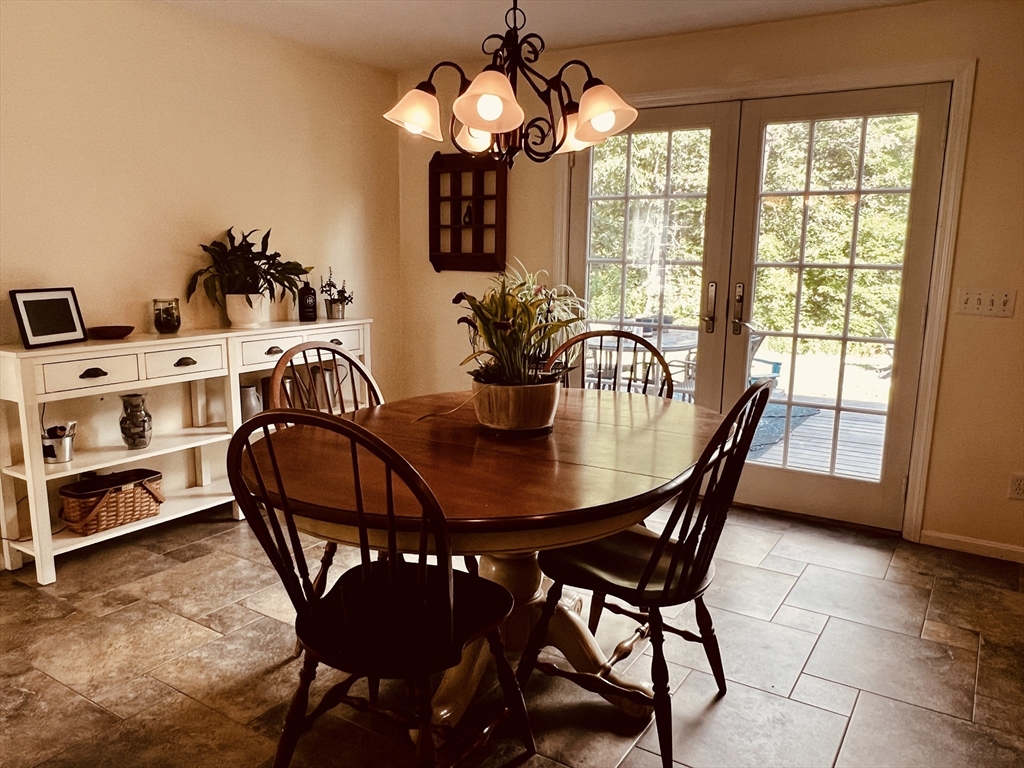 97 Breakneck Road Sturbridge, MA 01566 - Photo 15 of 33 a view of a dining room with furniture and chandelier