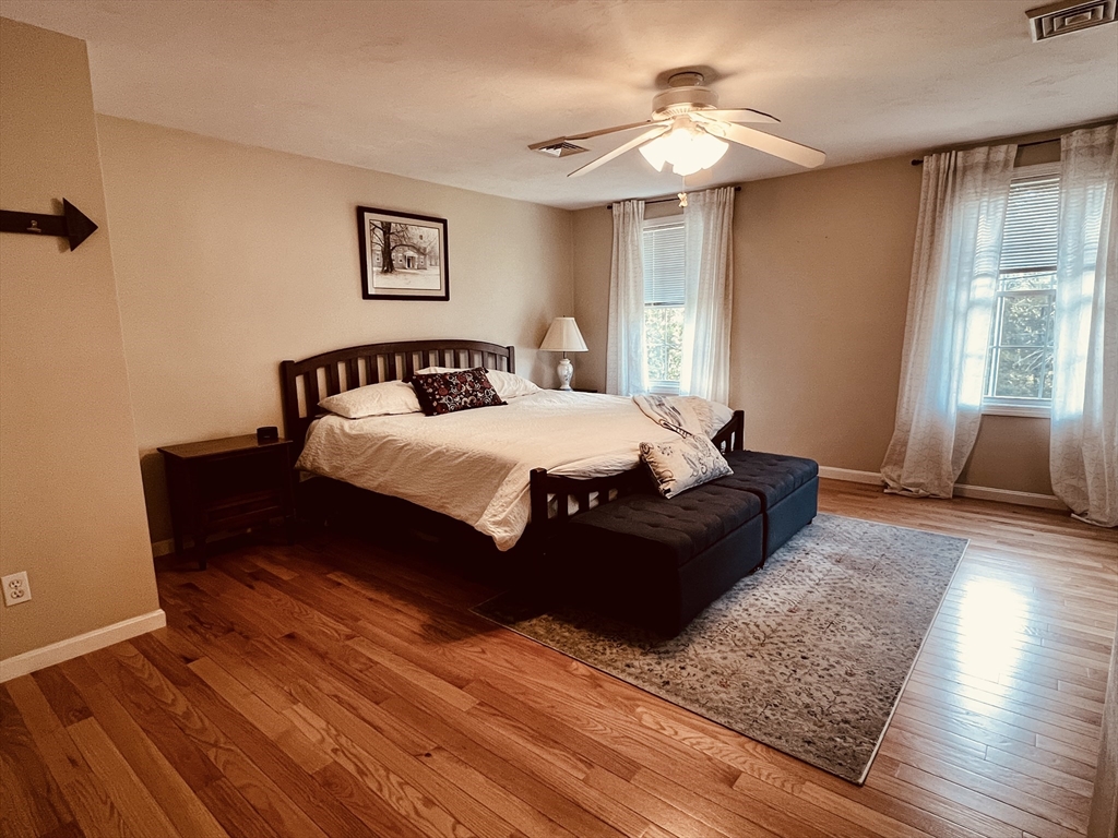 97 Breakneck Road Sturbridge, MA 01566 - Photo 18 of 33 a bedroom with a bed and a chandelier