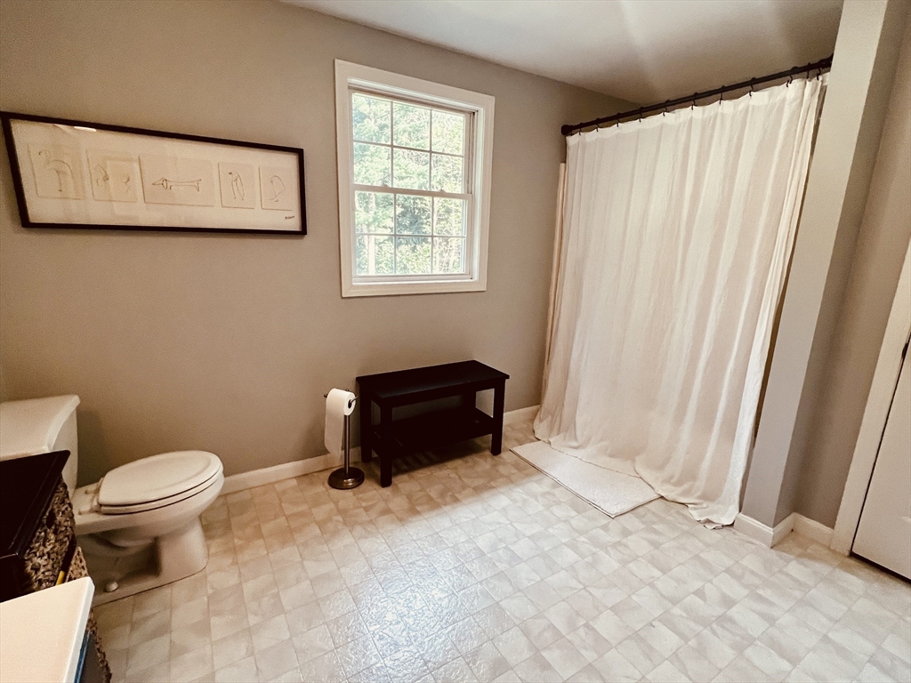 97 Breakneck Road Sturbridge, MA 01566 - Photo 20 of 33 a bathroom with a toilet a sink and a window