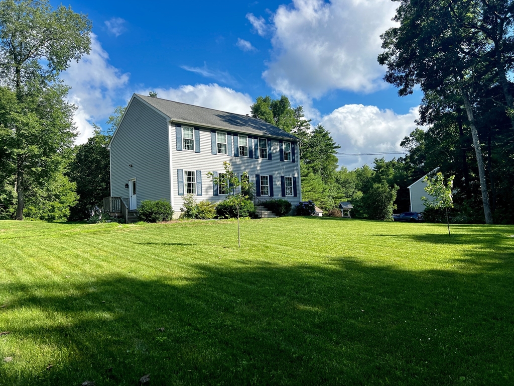 97 Breakneck Road Sturbridge, MA 01566 - Photo 2 of 33 a front view of a house with a garden