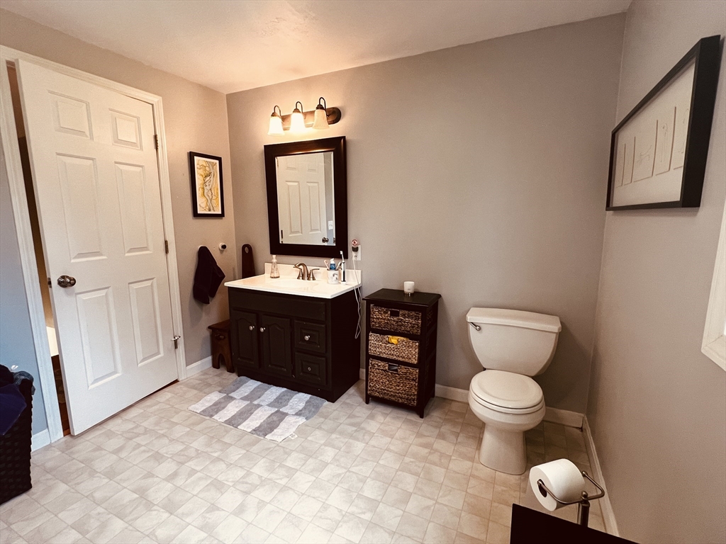97 Breakneck Road Sturbridge, MA 01566 - Photo 21 of 33 a spacious bathroom with a toilet sink and mirror