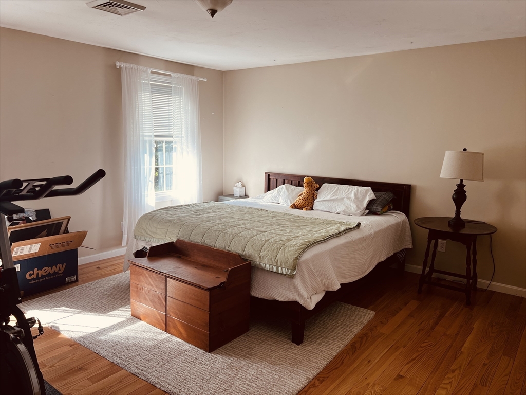 97 Breakneck Road Sturbridge, MA 01566 - Photo 25 of 33 a bedroom with a bed and wooden floor