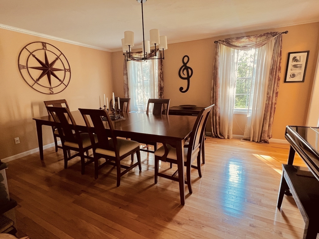 97 Breakneck Road Sturbridge, MA 01566 - Photo 7 of 33 a view of a dining room and livingroom with furniture wooden floor a chandelier