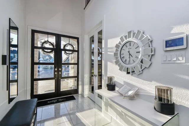 a view of a hallway with wooden floor and a living room