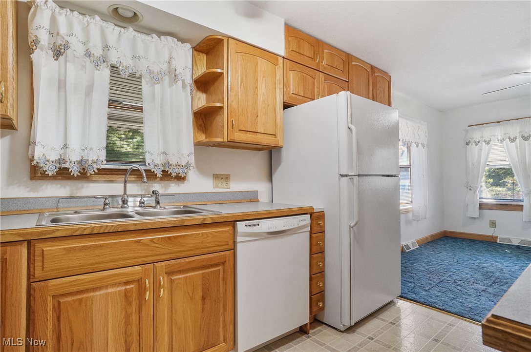 2809 McElwain Road Akron, OH 44312 - Photo 22 of 38 Kitchen with dishwasher, light countertops, open shelves, and linoleum