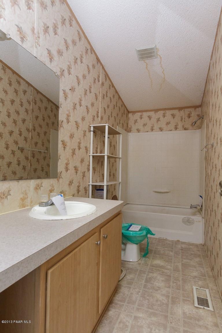 25375 North Stump Road Paulden, AZ 86334 - Photo 9 of 25 a bathroom with a sink a toilet and shower