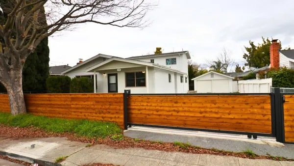 a front view of a house with a garden