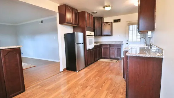 a kitchen with stainless steel appliances granite countertop a refrigerator sink and stove