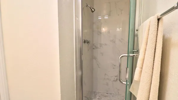 a bathroom with a glass shower door