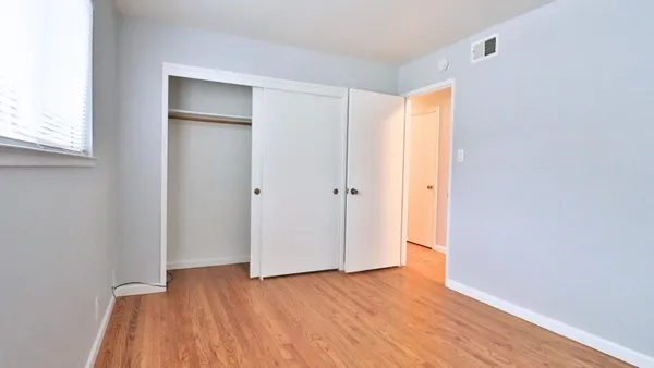 a view of hallway with wooden floor