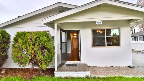 a front view of a house with garden