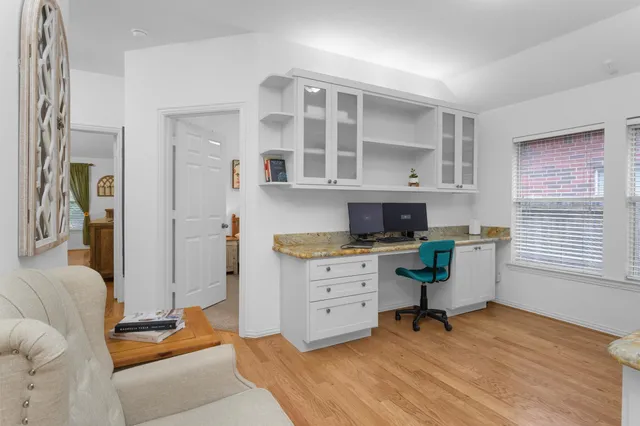 a bathroom with a granite countertop sink a large mirror and a bathtub