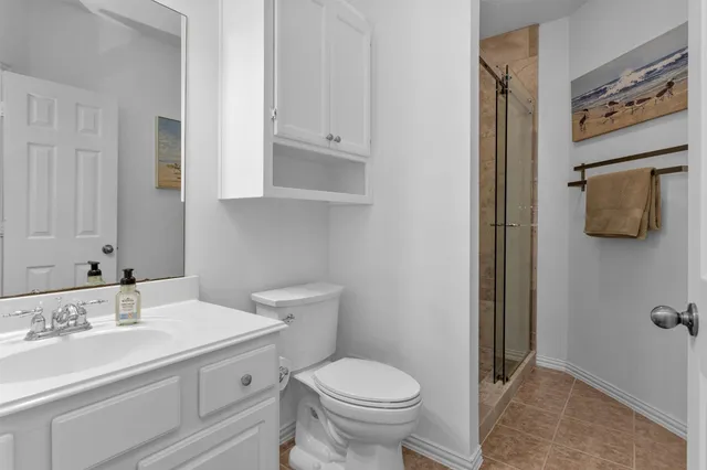 a view of a backyard with couches plants and large trees