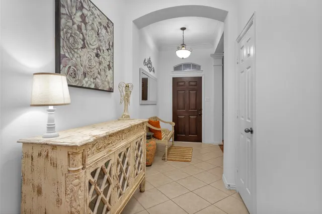 a view of a dining room with furniture a chandelier and wooden floor