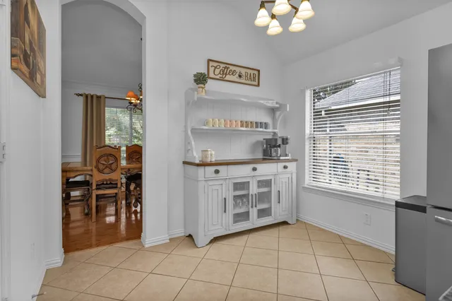 a kitchen with stainless steel appliances granite countertop a refrigerator a stove and a sink