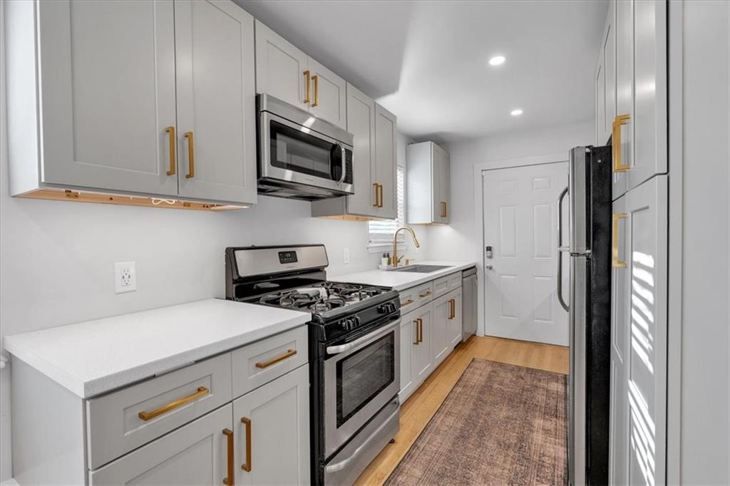 1520 Foote Street Northeast Atlanta, GA 30307 - Photo 13 of 39 a kitchen with stainless steel appliances granite countertop a stove a sink and a refrigerator