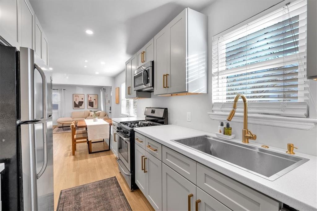 1520 Foote Street Northeast Atlanta, GA 30307 - Photo 14 of 39 a kitchen that has a sink a stove and chairs