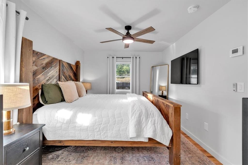 1520 Foote Street Northeast Atlanta, GA 30307 - Photo 17 of 39 a bedroom with a bed and a flat screen tv