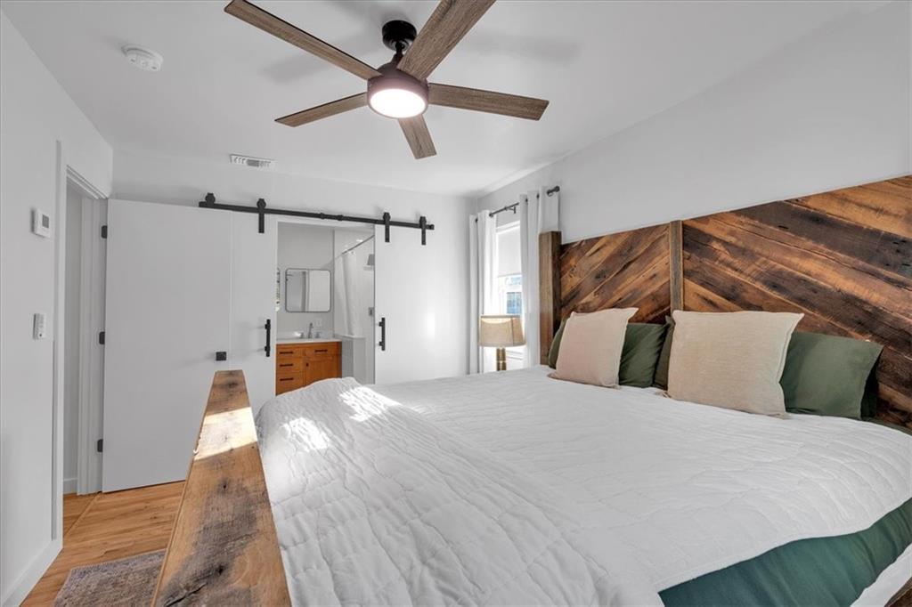 1520 Foote Street Northeast Atlanta, GA 30307 - Photo 19 of 39 a bedroom with a large bed and a ceiling fan