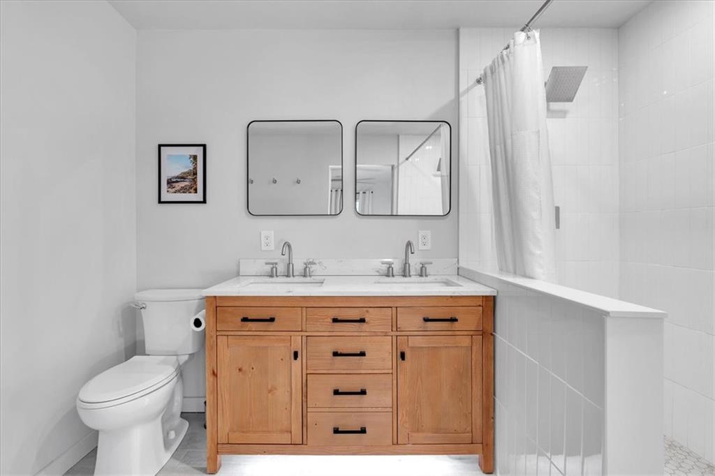 1520 Foote Street Northeast Atlanta, GA 30307 - Photo 21 of 39 a bathroom with a granite countertop toilet a sink and mirror