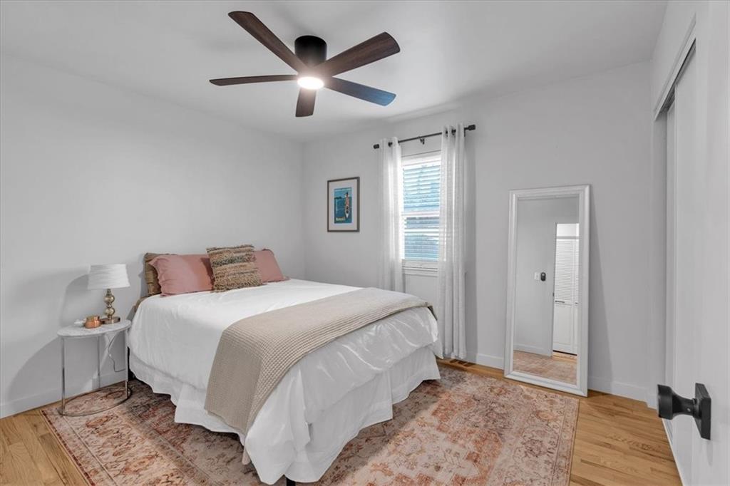 1520 Foote Street Northeast Atlanta, GA 30307 - Photo 27 of 39 a bedroom with a large bed and a chandelier