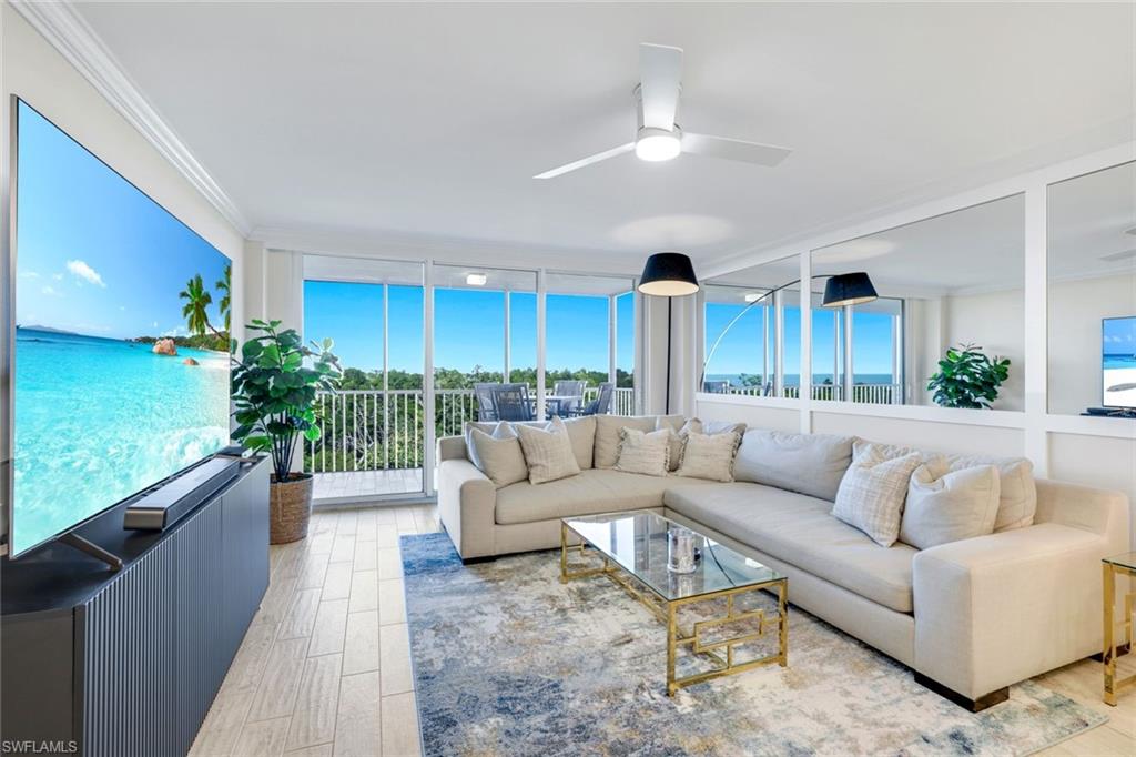 5 Bluebill Avenue, Unit 506 Naples, FL 34108 - Photo 1 of 25 a living room with furniture potted plant and a large window