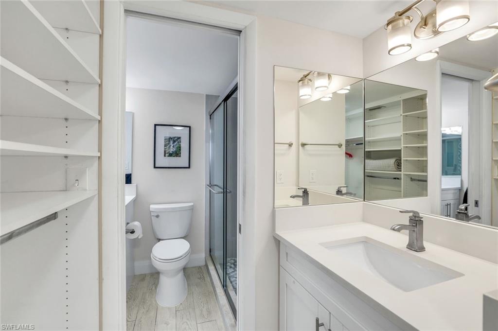 5 Bluebill Avenue, Unit 506 Naples, FL 34108 - Photo 13 of 25 a bathroom with a sink a toilet and shower