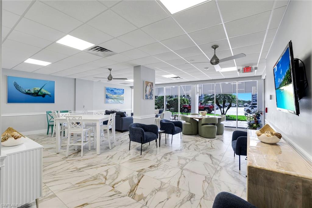 5 Bluebill Avenue, Unit 506 Naples, FL 34108 - Photo 17 of 25 a living room with lots of furniture and a flat screen tv