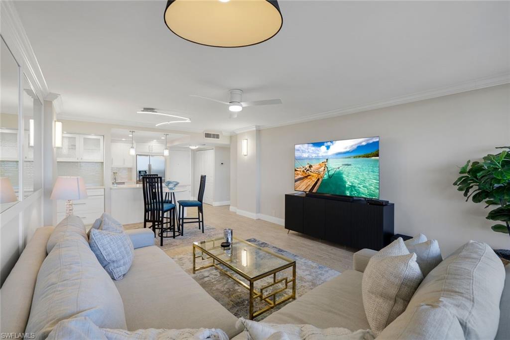5 Bluebill Avenue, Unit 506 Naples, FL 34108 - Photo 2 of 25 a living room with furniture and a flat screen tv