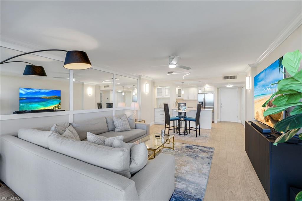 5 Bluebill Avenue, Unit 506 Naples, FL 34108 - Photo 3 of 25 a living room with furniture and a flat screen tv