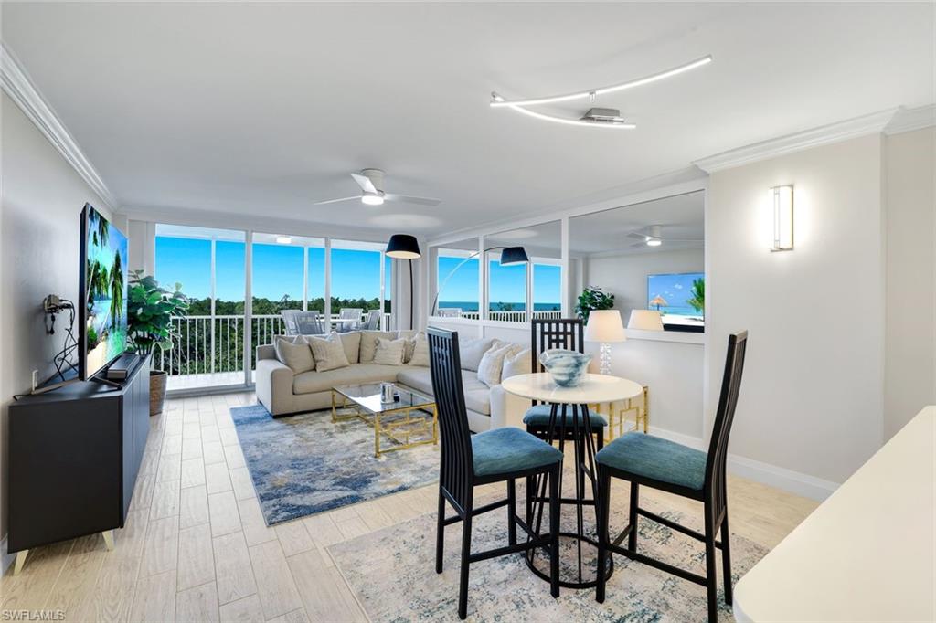 5 Bluebill Avenue, Unit 506 Naples, FL 34108 - Photo 8 of 25 a living room with lots of furniture and a large window