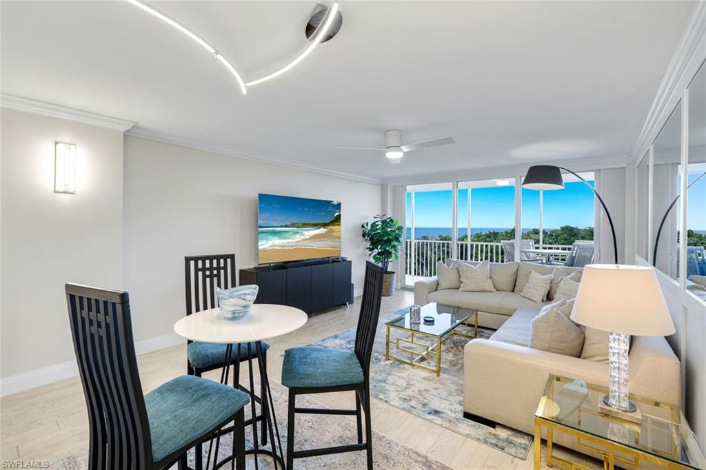 5 Bluebill Avenue, Unit 506 Naples, FL 34108 - Photo 9 of 25 a view of a dining room with furniture and wooden floor