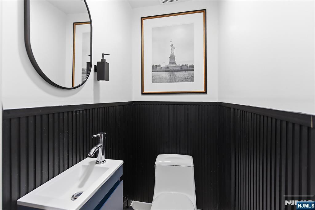 22 8th Avenue Newark, NJ 07104 - Photo 13 of 26 a bathroom with a toilet a sink and mirror