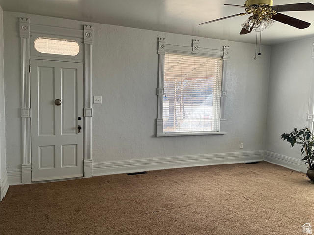 495 North Main Street Beaver, UT 84713 - Photo 13 of 18 Carpeted entrance foyer with a ceiling fan and a textured wall
