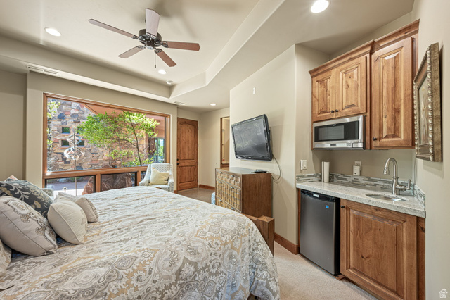 2331 West Entrada Trail, Unit 61 St. George, UT 84770 - Photo 51 of 69 Expansive window with wood trim overlooking exterior stone wall and mature tree